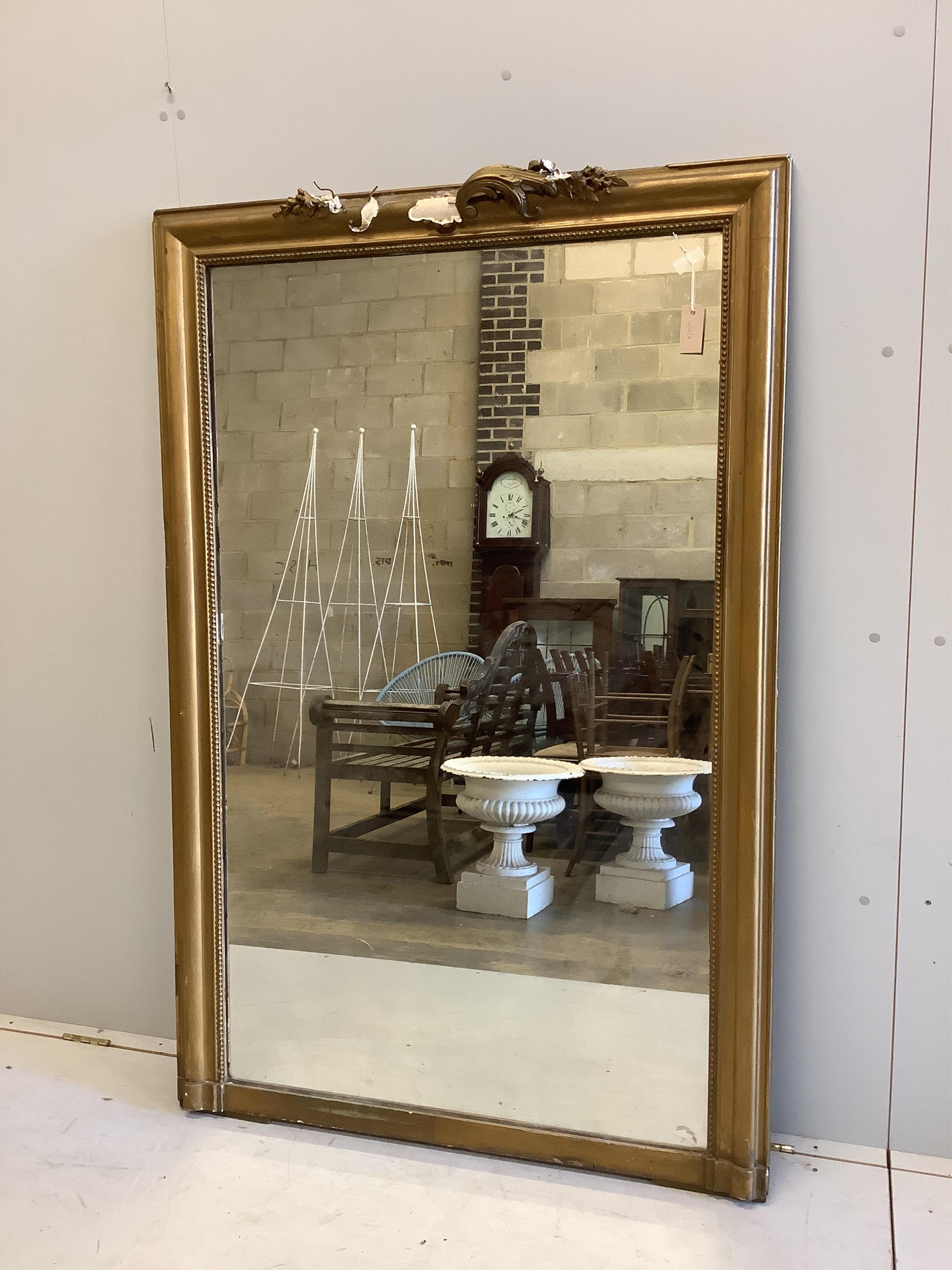 A large Victorian giltwood and composition wall mirror, width 107cm, height 166cm. Condition - poor, scroll pediment damaged, not all pieces present.